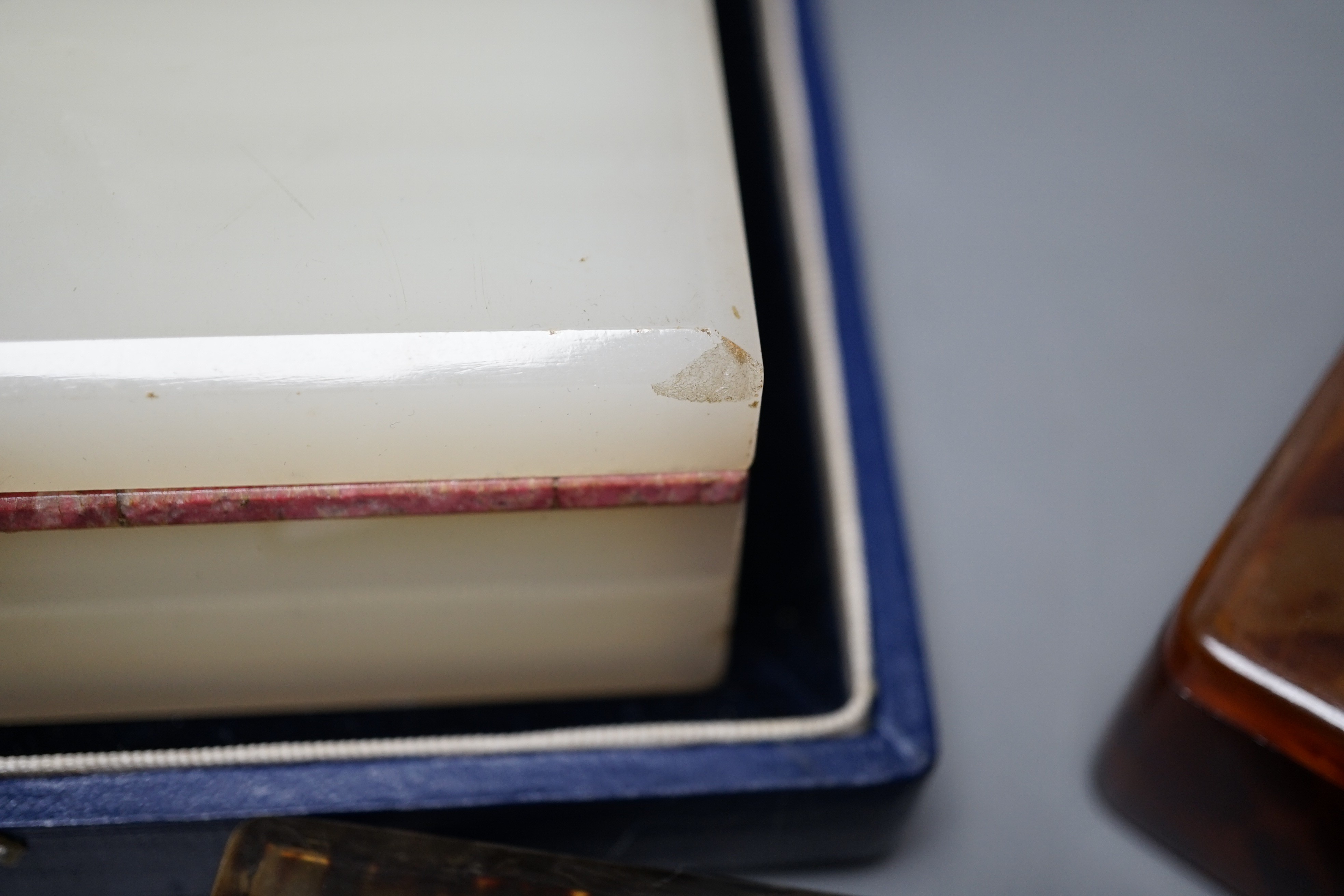 Two tortoiseshell boxes, an onyx cigarette box (does not fit case) and a Baltic amber handled silver paperknife